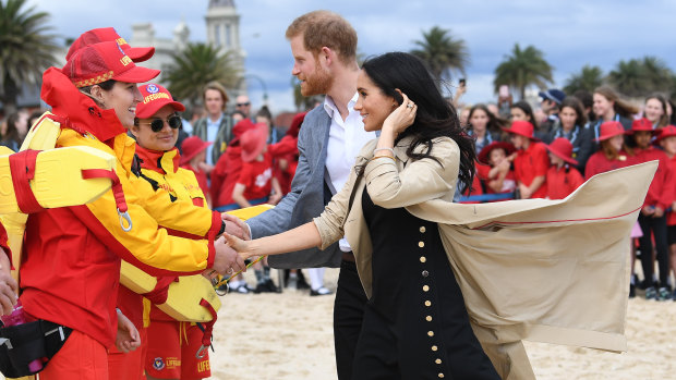 Harry and Meghan meet the lifesavers on South Melbourne beach.