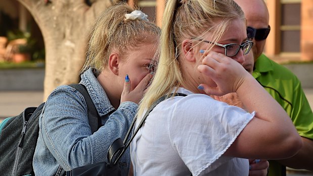 Two passengers cry after disembarking from The Ovation of the Seas cruise ship at Circular Quay.