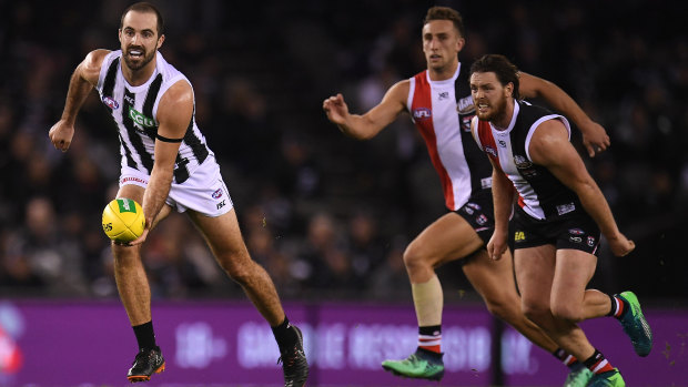 Field day: Magpie Steele Sidebottom gets away cleanly from his Saints opponents.
