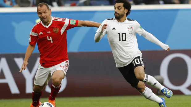 Sergei Ignashevich and Mohamed Salah contest the ball in the World Cup game between Russia and Egypt.