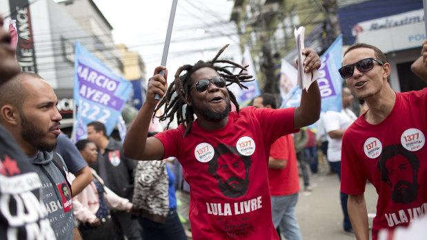 Supporters of Workers' Party candidate for vice-president Fernando Haddad shout slogans during a campaign rally in Rio.