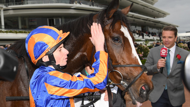 Ryan Moore pats Magic Wand after winning the Seppelt Mackinnon Stakes at Flemington on Saturday.