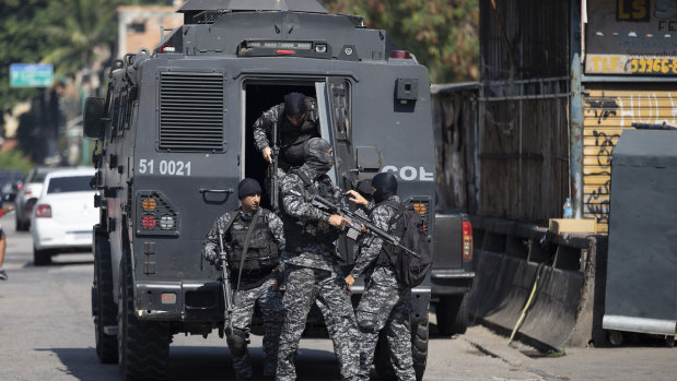 Police get out of an armored vehicle during an operation against alleged drug traffickers in the Jacarezinho favela of Rio de Janeiro, Brazil.