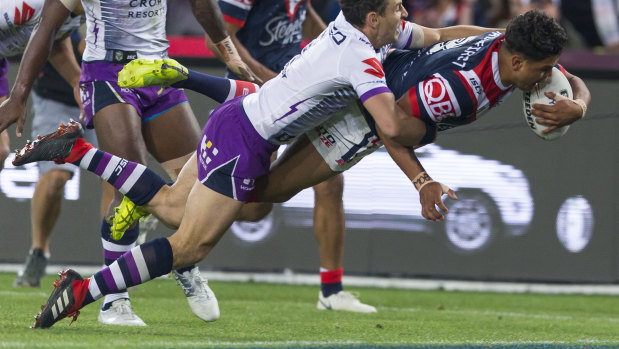 Grand final glory: Latrell Mitchell crashes through Melbourne fullback Billy Slater's attempted tackle to score a try.
