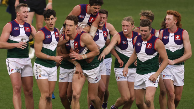 The Dockers celebrate a goal in their retro jersey worn in round 20 last season.