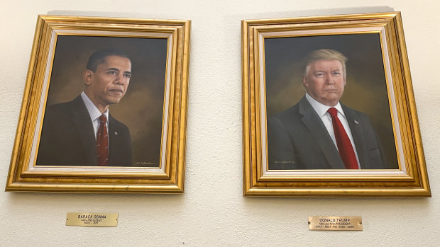 The Trump oil painting hangs next to a portrait of former president Barack Obama.