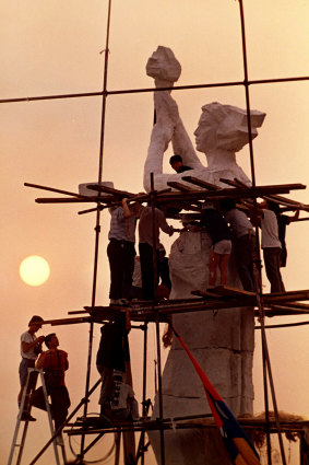 Protesters occupying Beijing's Tiananmen Square work on the statue of the Goddess of Democracy.  The statue was destroyed when the protest was put down.