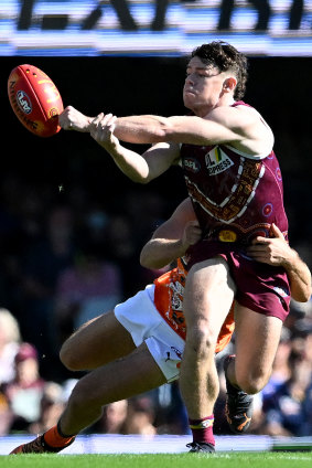 Lachie Neale gets a handball away.