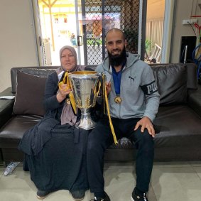 Bachar Houli with his mother, Yamama, and the 2019 premiership cup.