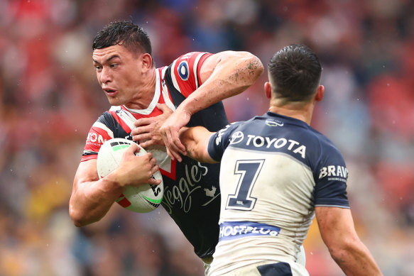 Roosters star Joseph Manu is tackled by Scott Drinkwater.