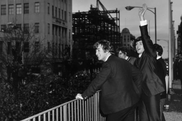 The Beatles wave to the fans from the first floor balcony of the Southern Cross Hotel, Melbourne.