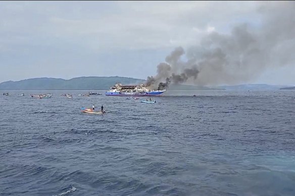 Smoke billows from passenger ferry KM Barcelona 5 after it caught fire in the waters off North Sulawesi on Sunday.