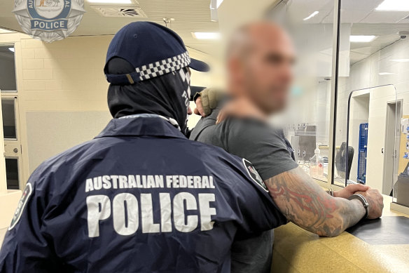 Comanchero boss Mark Buddle was taken into custody at Darwin on Wednesday.
