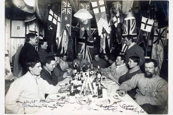 Explorer Robert Scott and his team enjoy a mid-winter dinner in June 1911.