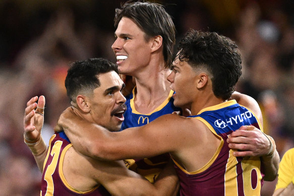 Charlie Cameron, Eric Hipwood and Cam Rayner of the Lions celebrate a goal during the AFL Preliminary Final clash with Carlton.