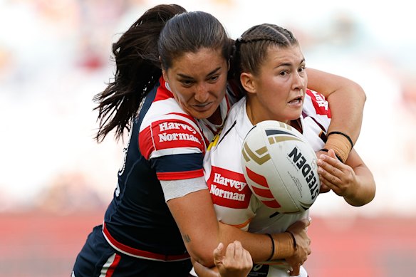 Jada Ferguson, pictured being tackled by Olivia Kernick, has become a State of Origin star and Broncos premiership champion since being drawn back to rugby league.