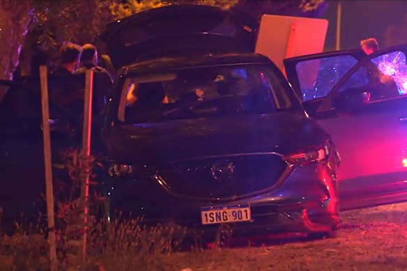 Police with a car that was involved in a pursuit through Perth’s north on Wednesday night.