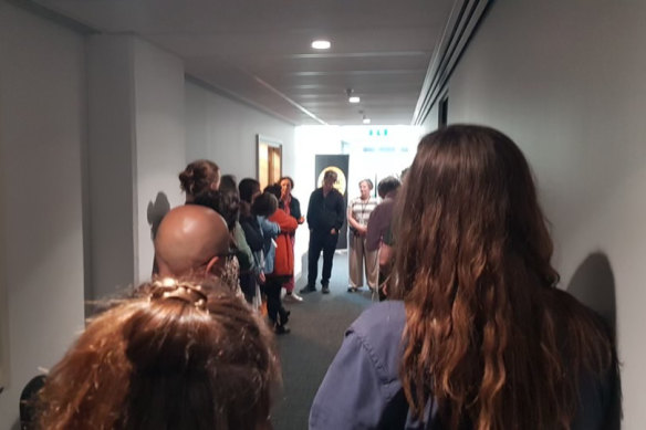 ABC staff line the corridor outside a studio after Sarah Macdonald said her contract had not been renewed