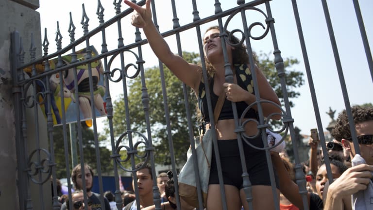Students and National Museum employees protested outside the institution. 