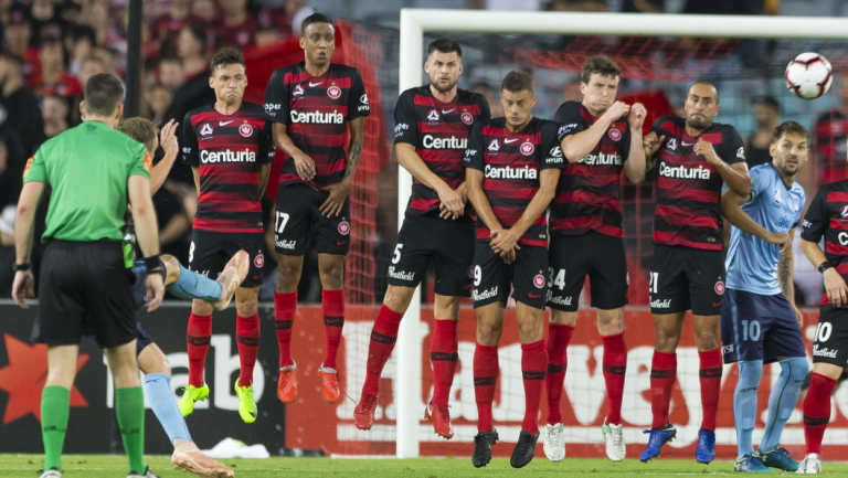 Late assault: Sydney FC try to bend a free kick around a Wanderers wall.