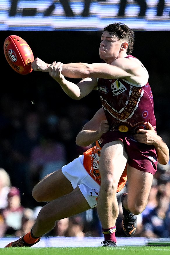 Lachie Neale gets a handball away.