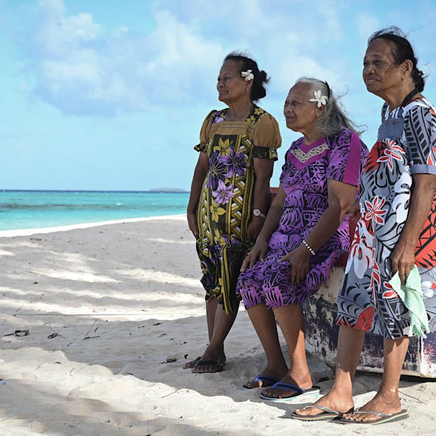 Castle Bravo survivors (from left) Susan Ned, Kathy Joel and Mina Titus on a beach on Mejatto Island in the Marshall Islands. Greenpeace flagship, the Rainbow Warrior III, is in the background.