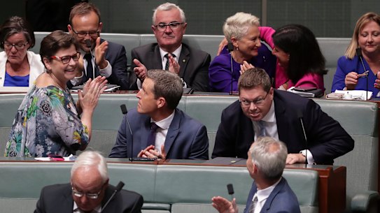 Crossbench MPs celebrate a win in Parliament.