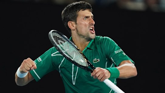 Novak Djokovic celebrates after winning the men's singles semi final against Roger Federer. 
