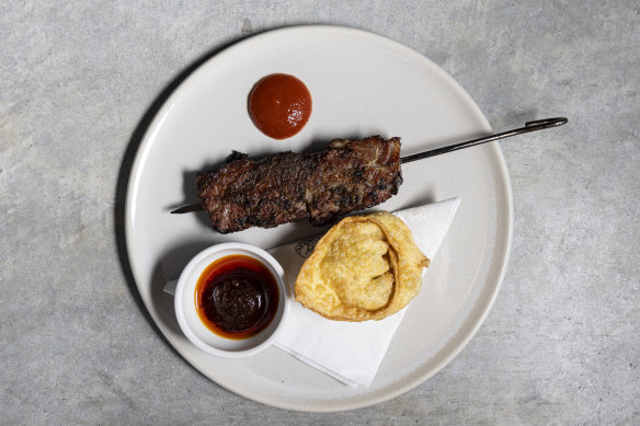 Snacks to start: Cumin-glazed lamb belly skewer and tofu-filled fried wonton with crispy chilli oil.