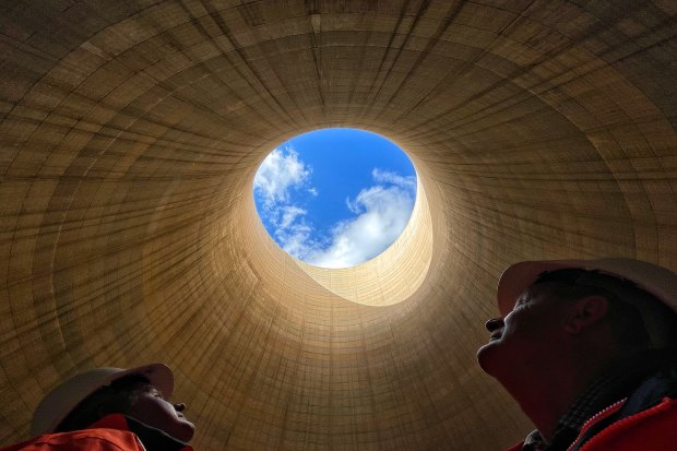 The ultimate echo chamber: Greenspot chief executive Brett Hawkins (left) and part owner Neil Schembri look skyward from inside the cooling tower of the shuttered Wallerawang Power Station. 