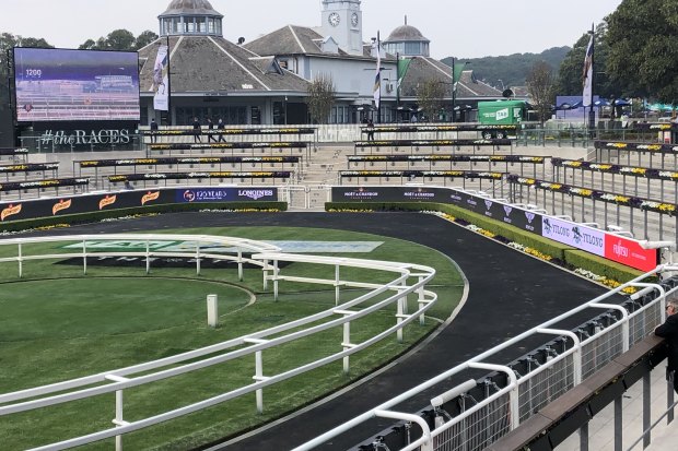 Les Bridge, trainer of the winner Classique Legend, watches The Everest by himself from the mounting yard.