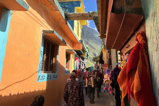 A pilgrim is carried through Mana village.
