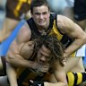 Ty Zantuck playing for Richmond in 2004, and tackling Hawthorn’s Mark Williams.