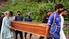Volunteers carry a body after recovering it from the rubble of a mosque damaged by a suspected Indian missile attack near Muzaffarabad in Pakistan-controlled Kashmir.