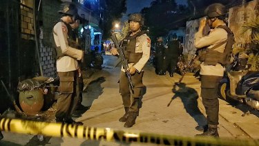 Armed police at a site where a suspected terrorist was shot dead and four members of his family apprehended after the Surabaya attacks.