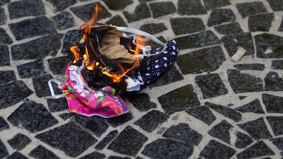 Protective masks are burned by supporters of Brazilian President Bolsonaro during a rally in favour of Bolsonaro's position that no one will be forced to use them and eventually get a coronavirus vaccine in Rio de Janeiro.