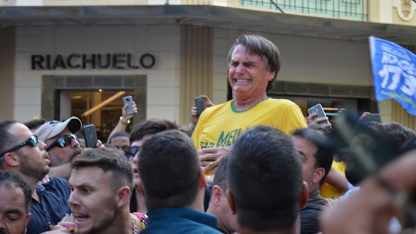 Presidential candidate Jair Bolsonaro grimaces after he was stabbed in the abdomen during a campaign rally in Juiz de Fora, Brazil, in 2018.