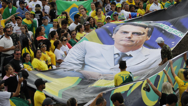 Supporters of Brazil's new President Jair Bolsonaro display a giant banner of him on his inauguration day in Brasilia, Brazil.