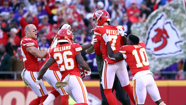 Harrison Butker (No.7) is mobbed by teammates after his game-winning field goal for Kansas City.
