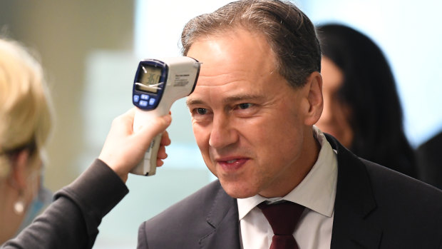 Federal Health Minister Greg Hunt, having his temperature checked before touring the Royal Melbourne Hospital, has delayed the vaping nicotine ban.