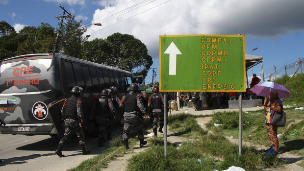 Police gather outside the Anisio Jobim Prison Complex after a deadly riot erupted among inmates in Manaus in the northern state of Amazonas.