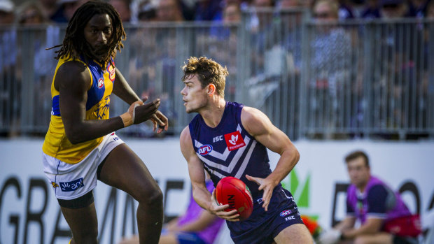 Hot pursuit: Fremantles Lachie Neale gets a break on Eagles' Nic Naitanui. 