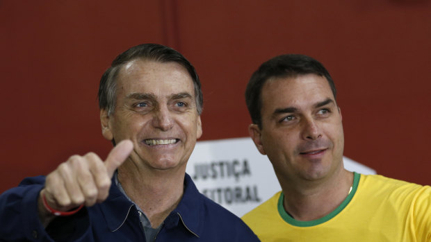 Jair Bolsonaro, left, and his son Flavio Bolsonaro, arrive at a Rio de Janeiro polling booth to vote in the election that elevated him to the Brazilian presidential office.