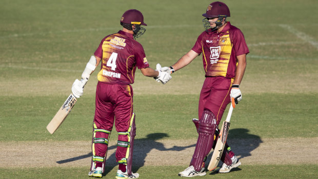 Bull run: Queensland's Mitch Swepson is congratulated by his teammate Xavier Bartlett after scoring a half century.