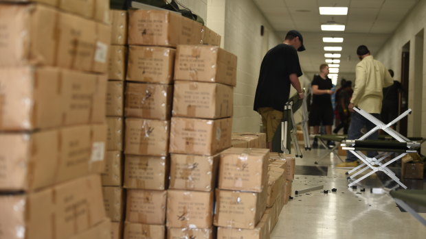 Volunteers assemble cots in an American Red Cross shelter in a Charleston, South Carolina.