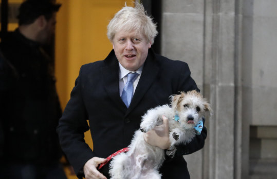 Like Donald Trump, Boris Johnson can be taken neither literally nor seriously ... the Prime Minister with his dog, Dilyn, after he voted in the general election in Westminster.
