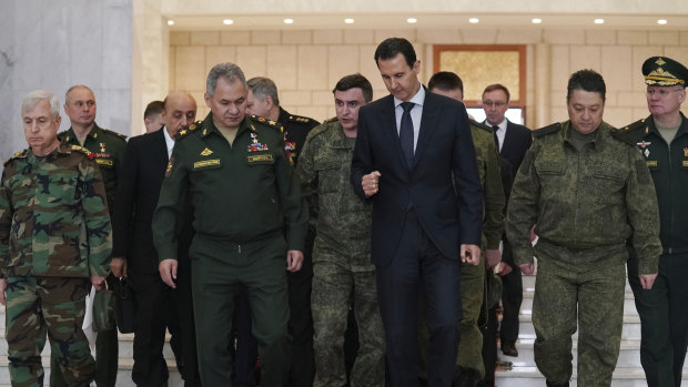 Syrian President Bashar al-Assad, centre right, speaks with Russian Defence Minister Sergei Shoigu, centre left, in Damascus. Russia has been a major ally of Assad, helping retake important cities from rebels.