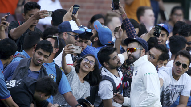 Star power: Rohit Sharma meets fans during a break in the tour match in Sydney.