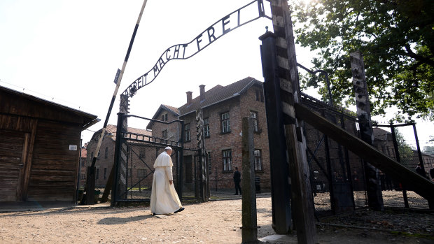 Pope Francis walks through the gate of the former Nazi German death camp of Auschwitz in Oswiecim, Poland, in  2016. 