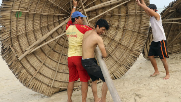 People remove beach cabanas ahead of typhoon Molave in Danang, Vietnam. 